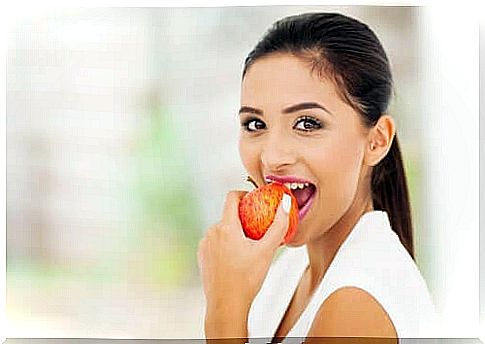 A woman eating an apple