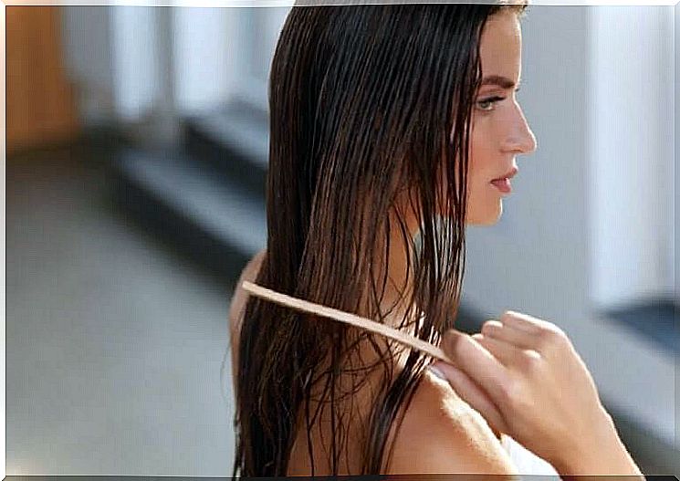 A woman combs her hair