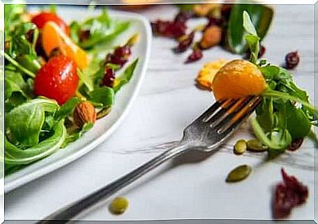 Green salad with citrus and dried fruits. 