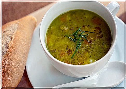 Soup with a piece of bread for dinner.