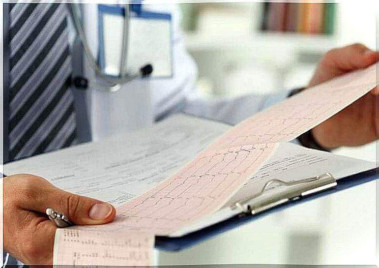 A doctor evaluating an electrocardiogram