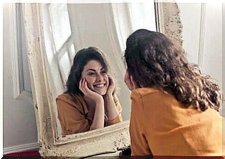 A woman looking at herself in a mirror.